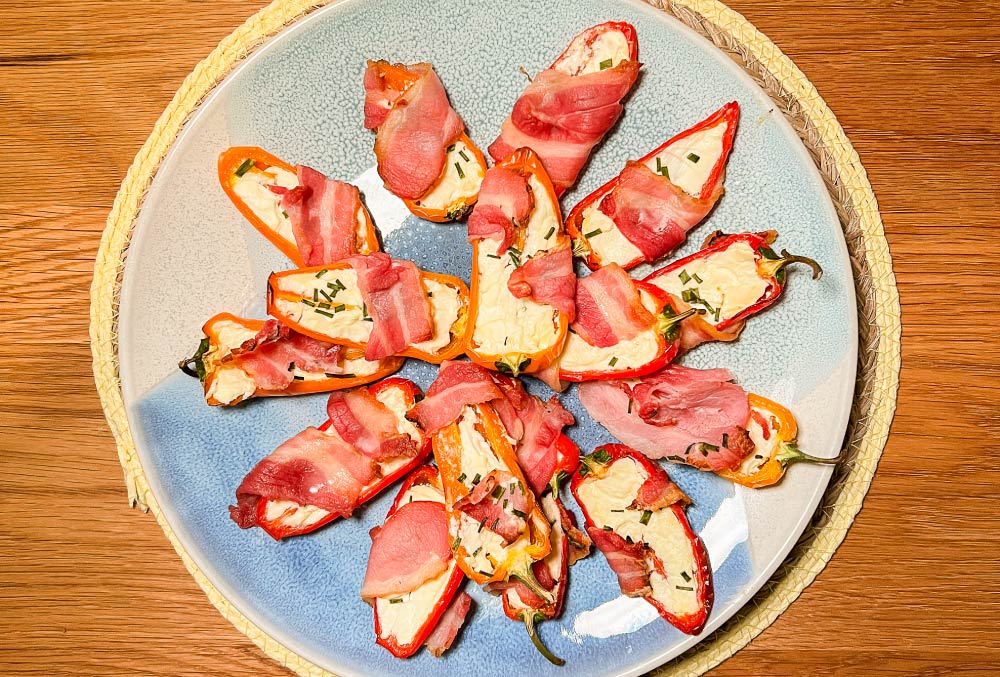 stuffed peppers with cream cheese wrapped in smoked bacon rashers and drizzled with sweet scotch bonnet hot sauce