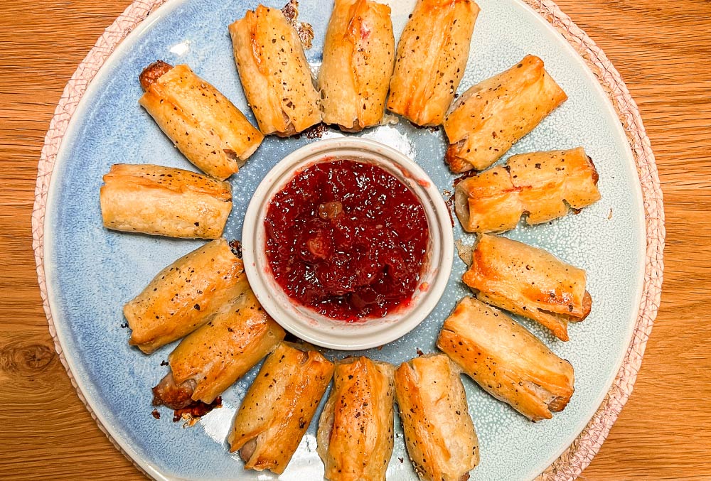 pigs in blanket wrapped in puff pastry with cranberry and tropical chilli jam dip for the ultimate party food